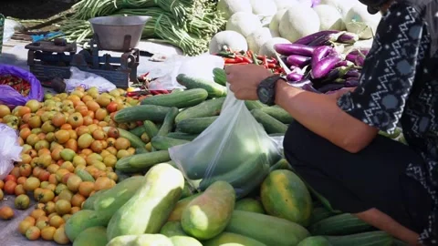 An Indonesian man is choosing vegetables Stock Footage 208309490
