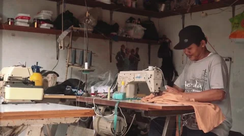 Indonesian man using sewing machine in a workshop, editorial Stock Footage 61022688
