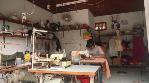 Indonesian man using sewing machine in a workshop, editorial Stock Footage 61022752