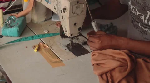 Indonesian man using sewing machine in a workshop Stock Footage 61022916