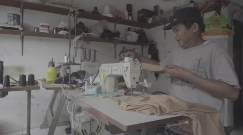 Indonesian man using sewing machine in a workshop, editorial, ungraded, slog2 Stock Footage 61023098