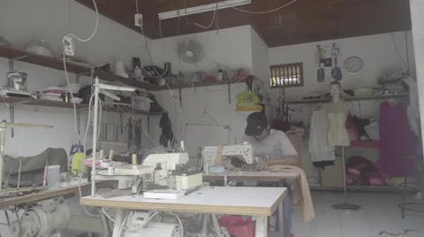 Indonesian man using sewing machine in a workshop, editorial, ungraded, slog2 Stock Footage 61023117