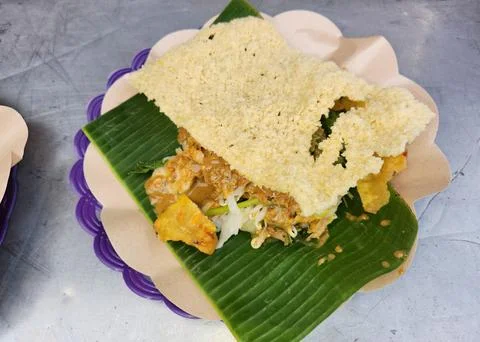 Indonesian pecel platter with crispy cracker. Stock Photos