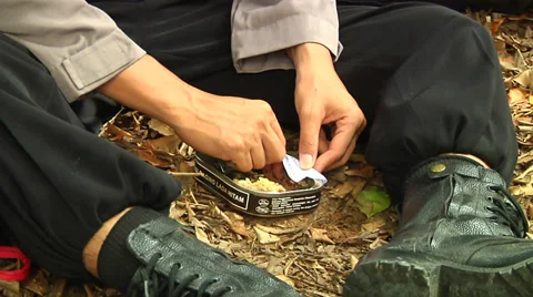 Indonesian policeman eats in jungle Stock Footage 34453597