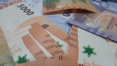 Indonesian Rupiah Banknotes - Camera flying close up over a stack - Banknot.. Stock Footage 270441736