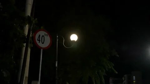 Indonesian speed limit 40 km/h road sign at night, medium shot Stock Footage 139548285