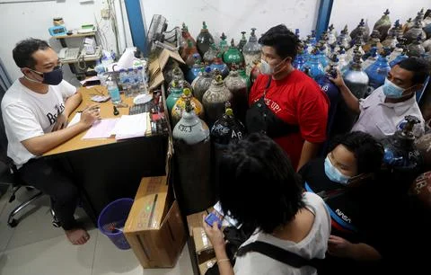 Indonesians queue for oxygen amid rising number of COVID-19 cases in Jakarta, In Stock Photos