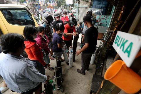 Indonesians queue for oxygen amid rising number of COVID-19 cases in Jakarta, In Stock Photos