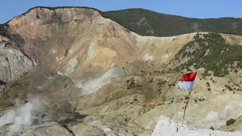 Indonesia's Flag "Sang Saka Merah Putih" on Tebing Soni, Mount Papandayan Stock Footage