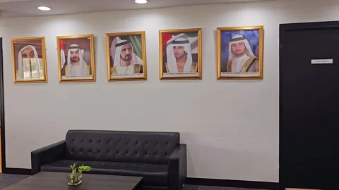Indoor area with five framed portraits of Middle Eastern UAE leaders Stock Footage 312002684