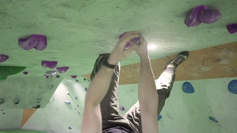 Indoor climber climbing bouldering excercise leisure ceiling upside down gimb Stock Footage 100330633
