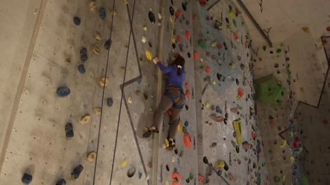 Indoor climbing training with a long reach for the next hold. Stock Footage 339287801