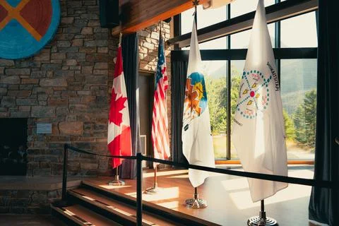 Indoor display of flags: Canada, USA, and indigenous nations united together. Stock Photos