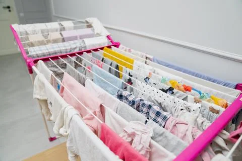 Indoor drying rack fully loaded with freshly washed clothes Stock Photos