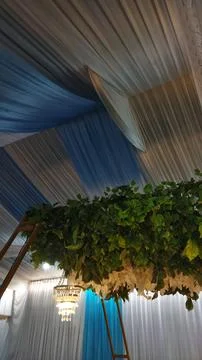 Indoor event space featuring draped fabric ceiling in shades of blue and beig Stock Photos