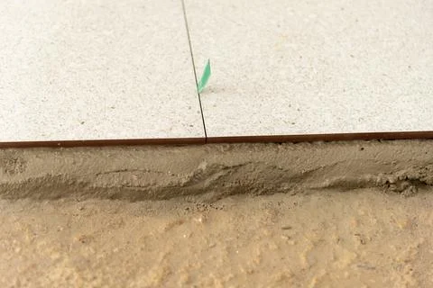 Indoor floor tile installation process a close-up view of construction detail Stock Photos