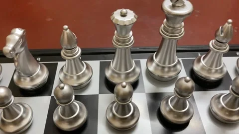 Indoor game: Silver colored chess pieces arranged on a board, ready to start Stock Footage 333271846