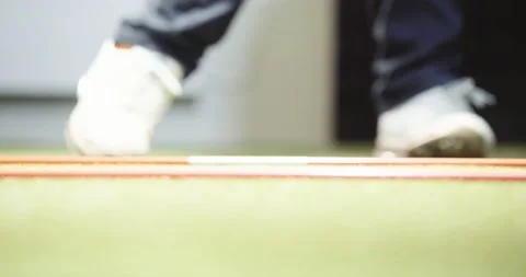 Indoor golf simulator, golfer drives ball into golf simulation program 4k Stock Footage 163990880