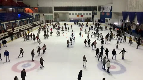 Indoor ice skating by group of different people Stock Footage 235142088