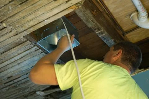 Indoor installing vents in the ceiling. Stock Photos