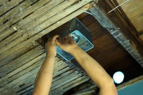 Indoor installing vents in the ceiling. Stock Photos