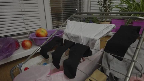 Indoor Laundry Drying Rack With Black Socks, White Underwear And Apples Vídeos de archivo 346042835