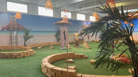 Indoor mini golf course with tropical themed obstacles. Stock Footage 341678319