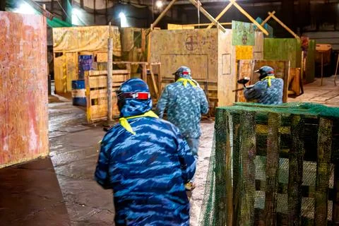 Indoor paintball - fast attack at the beginning of the game, movement blur Stock Photos