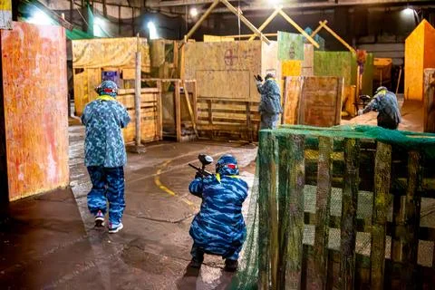 Indoor paintball - fast attack, dynamic blur Stock Photos