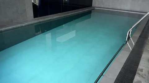Indoor pool spa wellness water hotel luxury relaxation ladder tiled interior vie Stock Footage 332875167