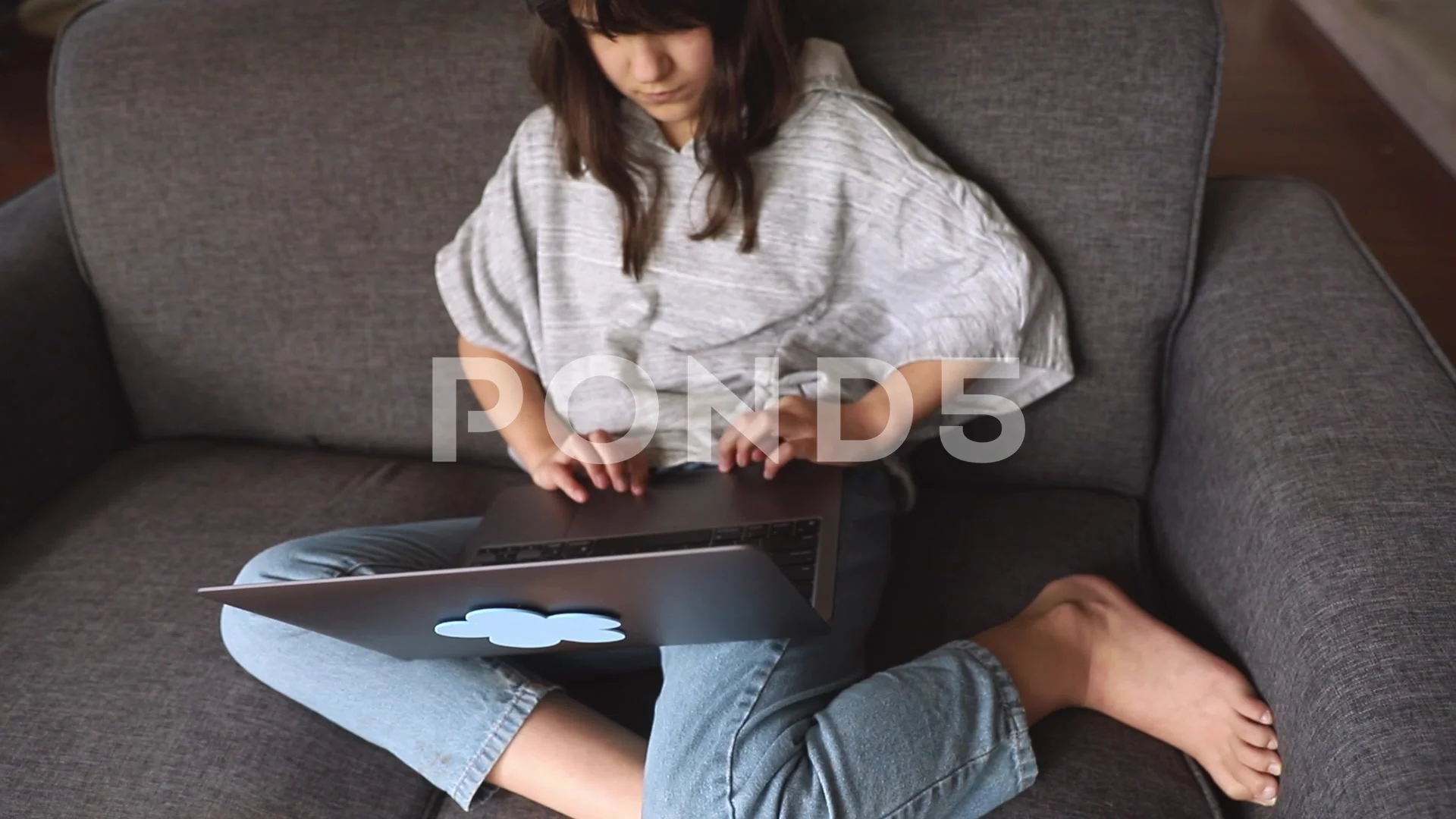 indoor portrait of pre-teen girl doing homework online or browsing internet
