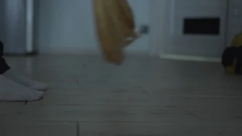 An indoor scene featuring broom cleaning complemented by the presence of bare Stock Footage 318544409