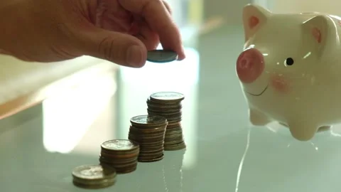 Indoor shot. Selective focus, close up at men hand put coins into increase st Stock Footage