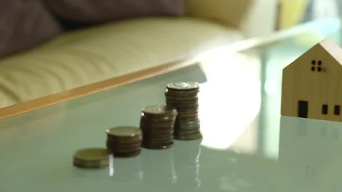 Indoor shot, selective focus at men hand put wooden house mock up beside incr Video stock 146363899