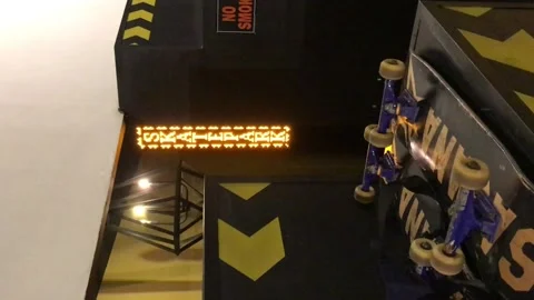 Indoor skatepark with running text Stock Footage 220872626