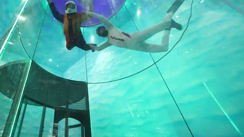 Indoor skydiving instructor with student india Stock Footage 171467456