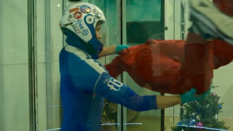 Indoor skydiving training in a vertical wind tunnel Video stock 324860887