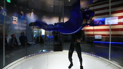 Indoor skydiving wind tunnel man fun turn flight 4K 스톡 동영상 120378426
