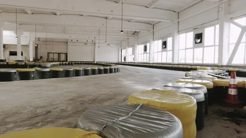 Indoor static view go kart racing circuit with empty track, safety barriers.. Video stock 315494648