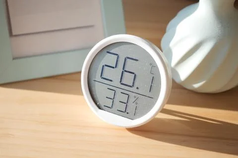 Indoor temperature and humidity display on wooden table Stock Photos
