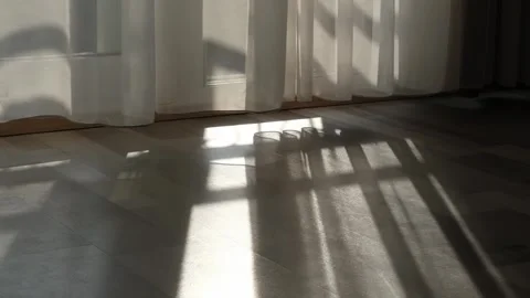 Indoor tranquility: curtain flutters as the wind whispers through an open Stock Footage 255128593