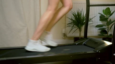 Indoor treadmill jogging during home cardio workout in modern apartment fitness Video stock 335816975