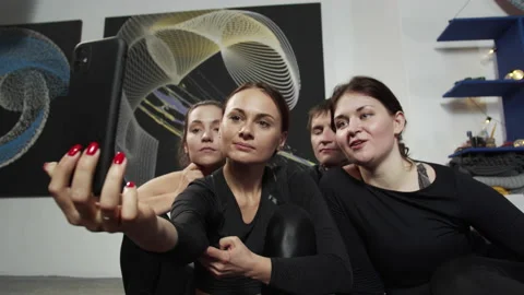 Indoor video of flexible active people sitting on floor in front of the camera Stock Footage 156823814