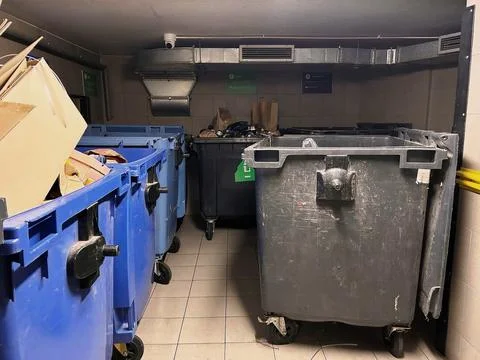 Indoor waste sorting station with large bins. Stock Photos