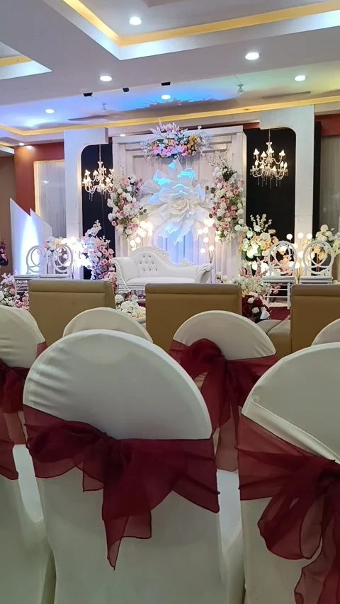 Indoor wedding reception featuring decorated chairs, suitable for event planners Stock-Footage 333117099