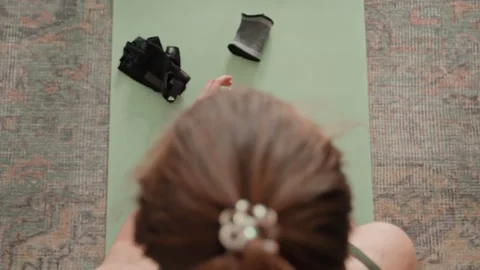 Indoor workout setup with accessories. Caucasian woman organizes training tools Stock Footage 342422430