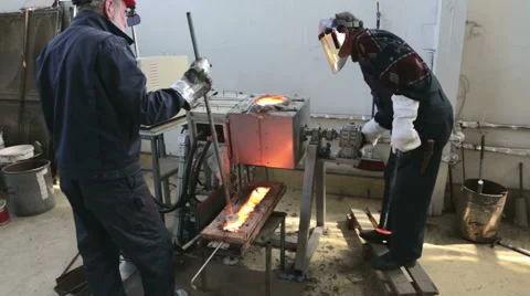 Induction melting workshop engineers cast ingot. Stock Footage 50500219