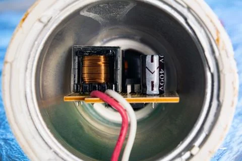 Inductor, condenser and microcircuit inside the LED lamp Stock Photos