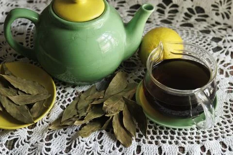 Indulge in Aromatic Leaf Tea served in a Green Teapot with a twist of Lemon.. Stock Photos