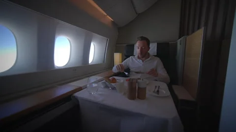 Indulge in a Luxurious Dining Experience While Flying FirstClass on a Stock Footage 319909878